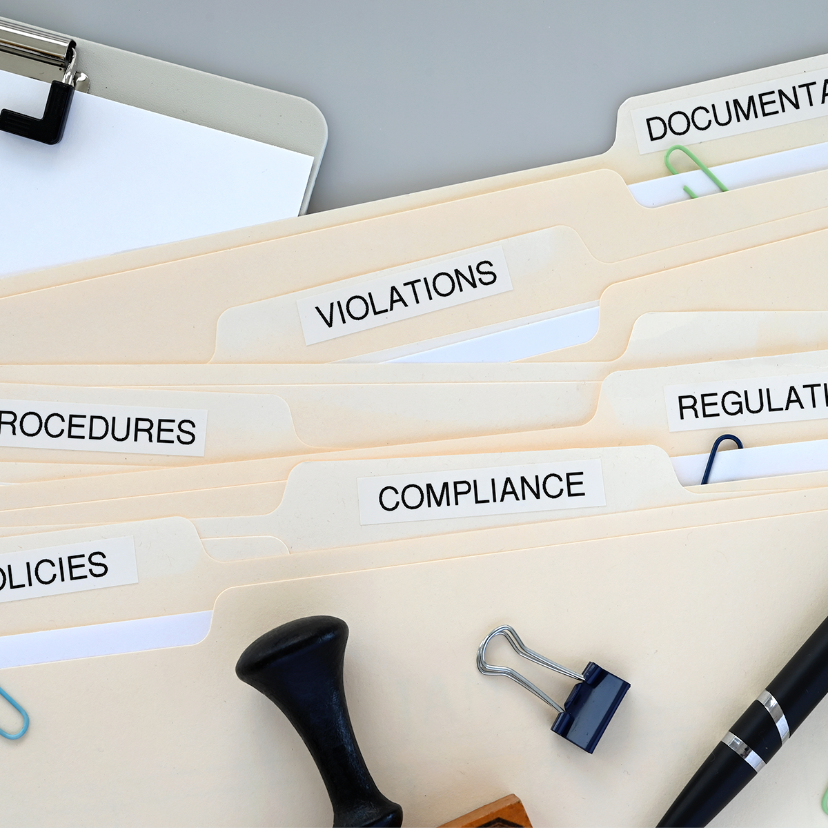 Compliance folders and documents organised for business regulation.